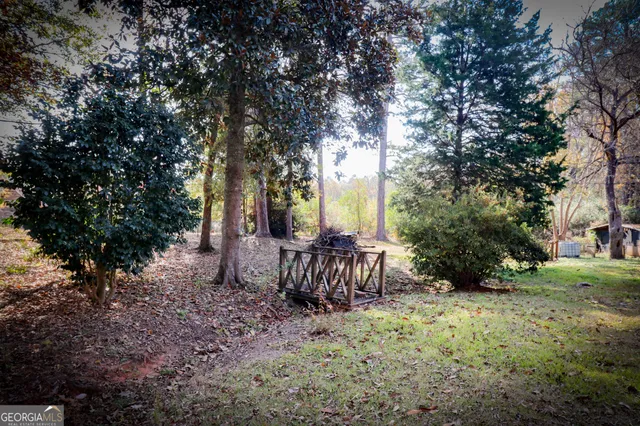 a backyard of a house with table and chairs