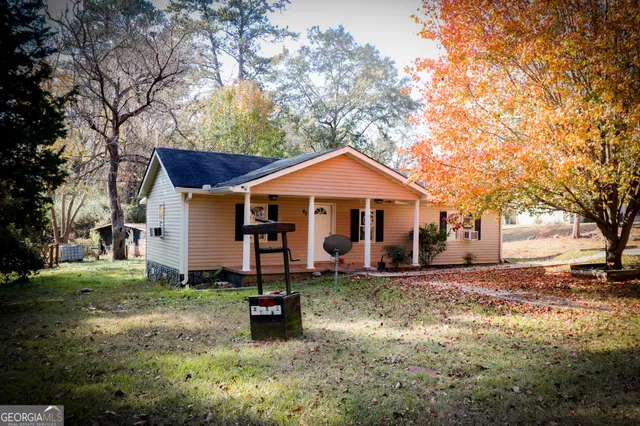 a view of a house with yard and a tree