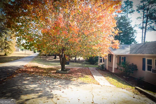 a view of a house with yard and a garden