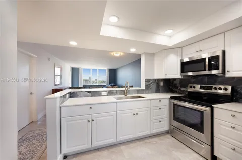 a kitchen with a sink stove and microwave