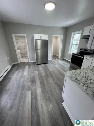 a kitchen with sink and refrigerator