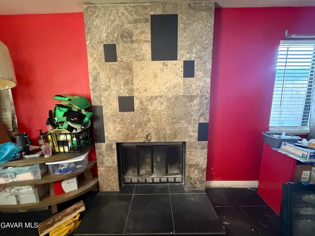 a view of a hallway with wooden floor and a living room