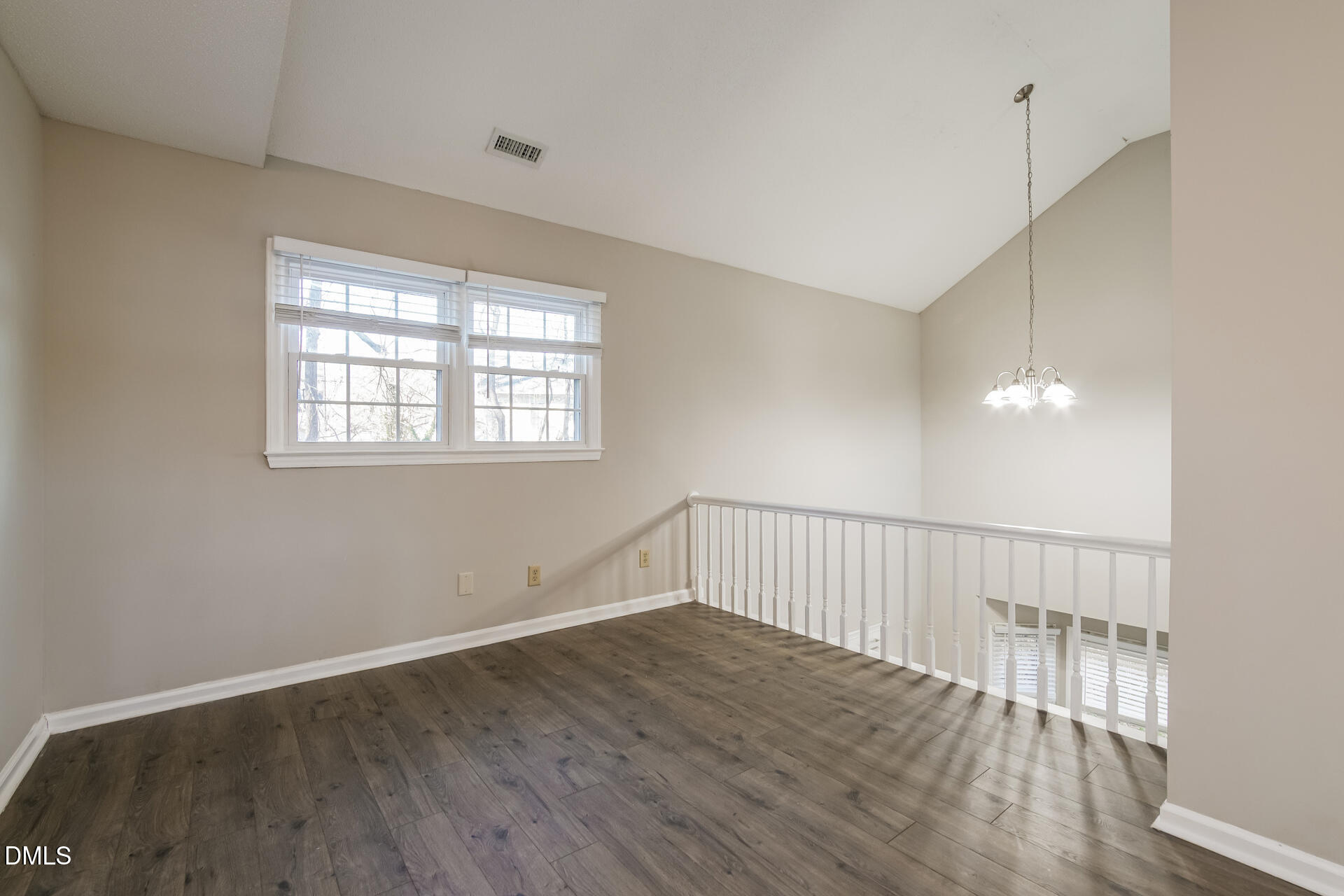1909 Kushima Court Raleigh, NC 27604 - Photo 9 of 24 a view of an empty room with wooden floor and a window