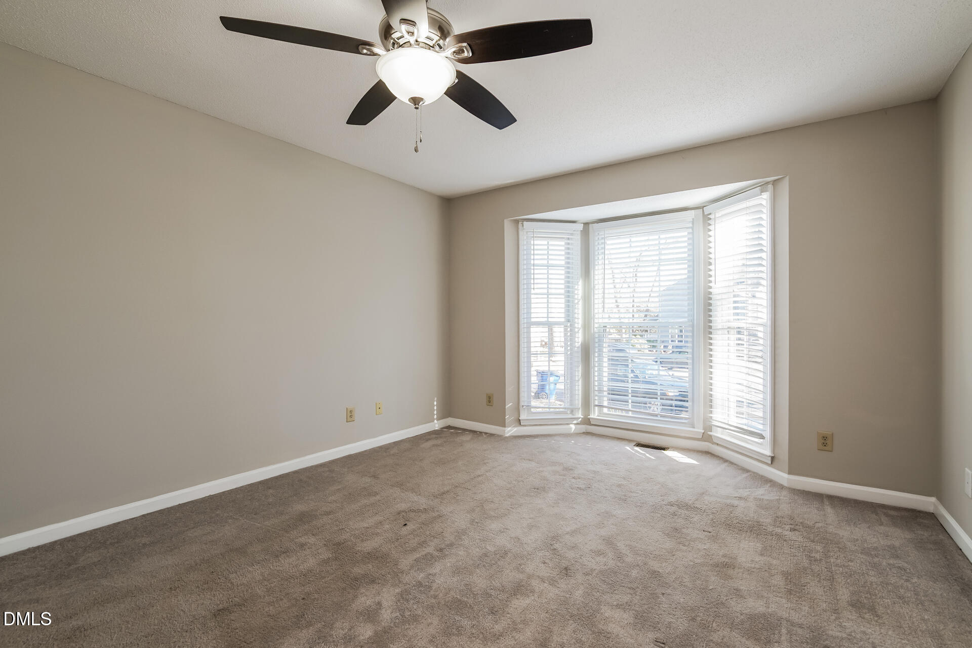 1909 Kushima Court Raleigh, NC 27604 - Photo 13 of 24 an empty room with chandelier fan and windows