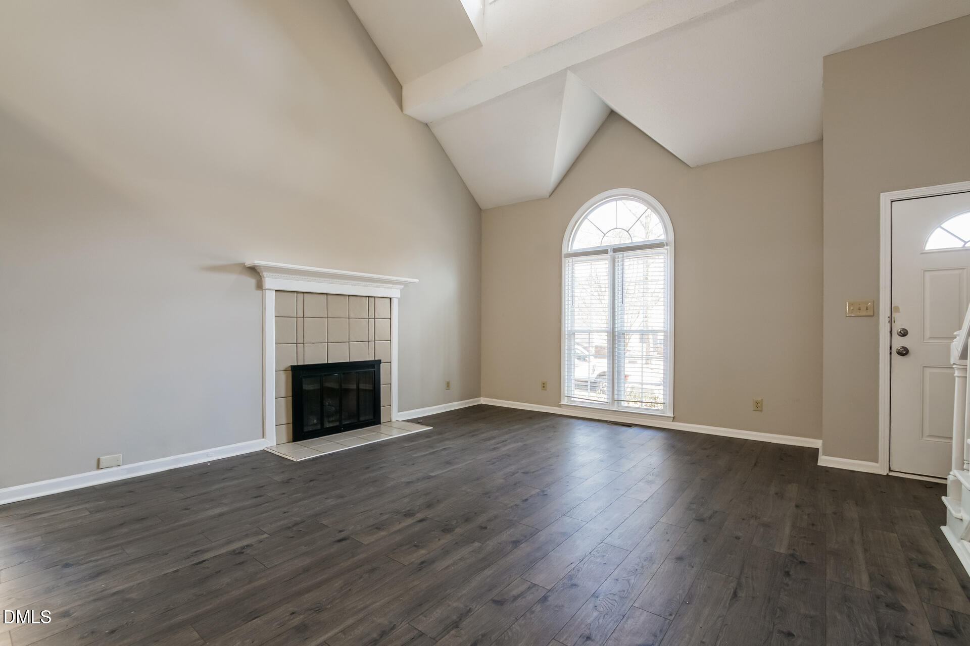 1909 Kushima Court Raleigh, NC 27604 - Photo 3 of 24 an empty room with wooden floor fireplace and windows