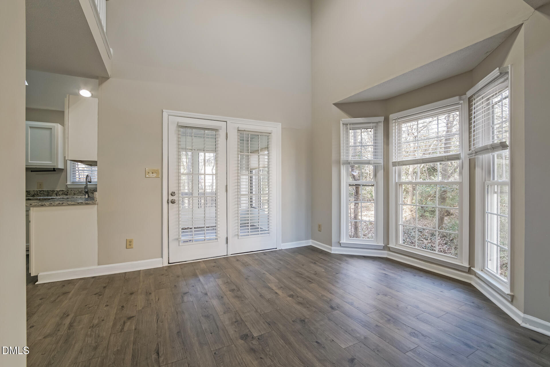 1909 Kushima Court Raleigh, NC 27604 - Photo 6 of 24 a view of an empty room with wooden floor and a window