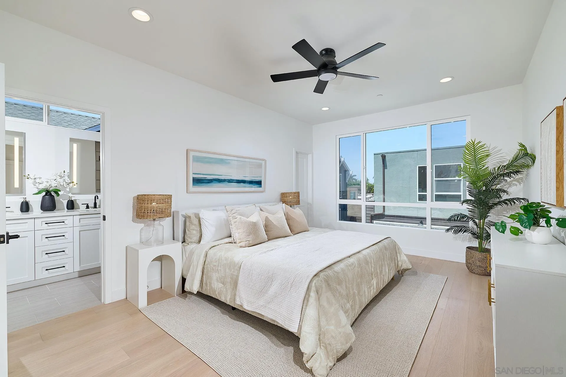 557 North Vulcan Avenue Encinitas, CA 92024 - Photo 12 of 27 a bedroom with a large bed and a chandelier