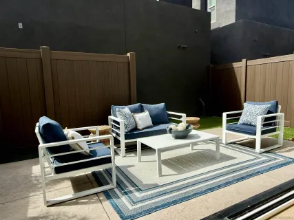 a view of a chairs and table in the balcony