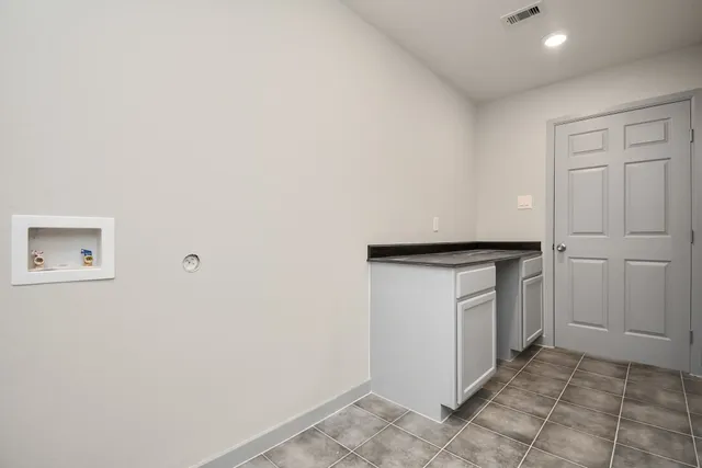 a utility room with cabinets washer and dryer