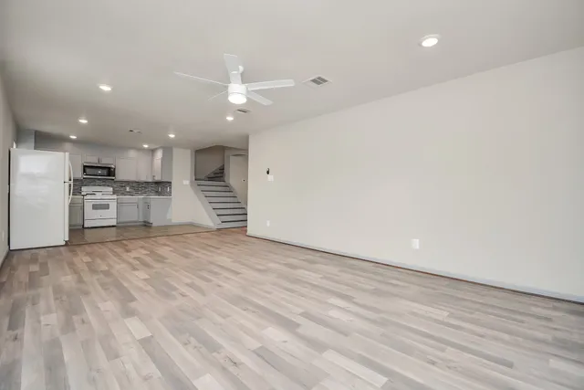 a view of an empty room with a kitchen