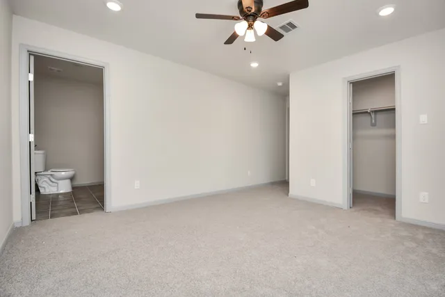 wooden floor in an empty room and a bathroom