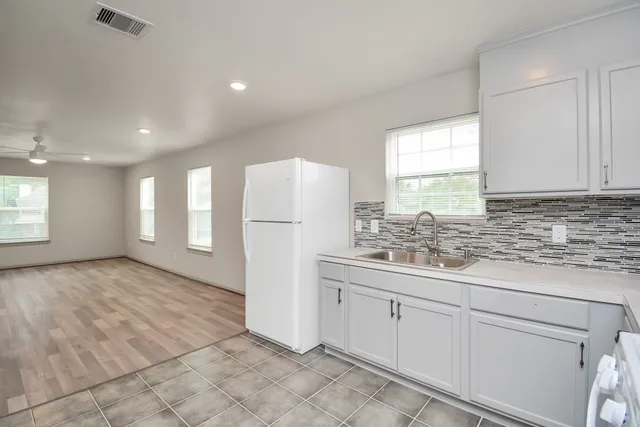 a bathroom with a sink a mirror and a shower