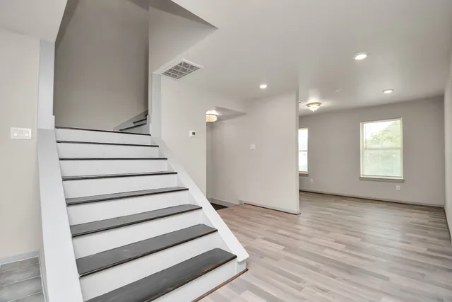 a view of entryway with wooden floor and front door