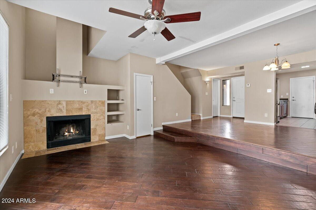 10115 East Mountain View Road, Unit 1102 Scottsdale, AZ 85258 - Photo 11 of 31 a view of a room with fireplace and wooden floor
