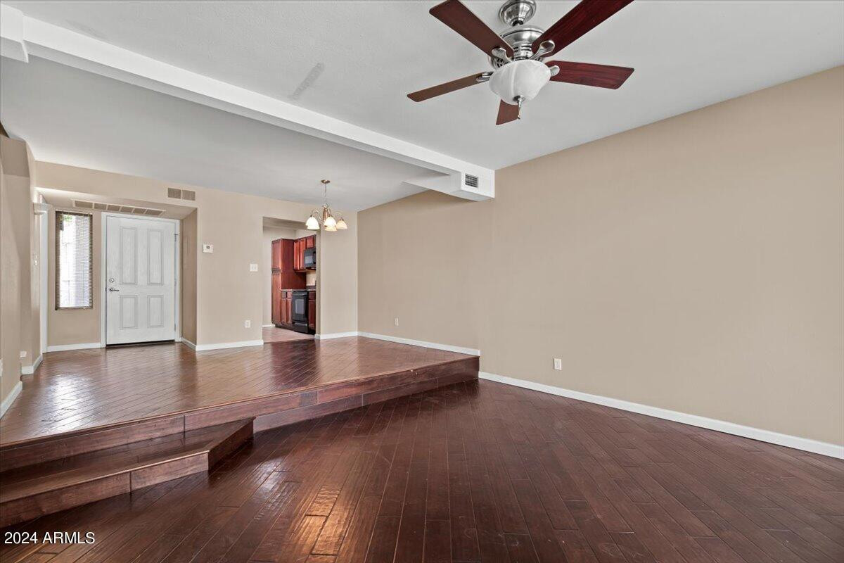 10115 East Mountain View Road, Unit 1102 Scottsdale, AZ 85258 - Photo 12 of 31 a view of an empty room with window and wooden floor