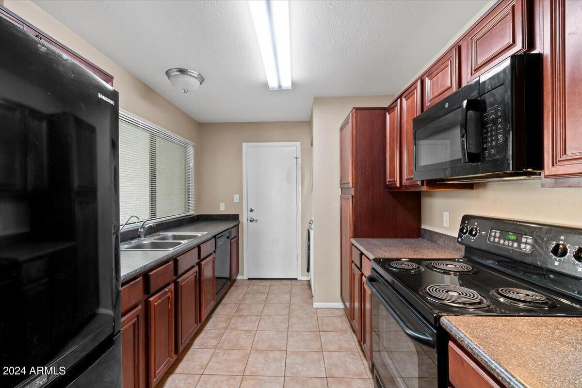 10115 East Mountain View Road, Unit 1102 Scottsdale, AZ 85258 - Photo 13 of 31 a kitchen with stainless steel appliances a stove a sink and a microwave