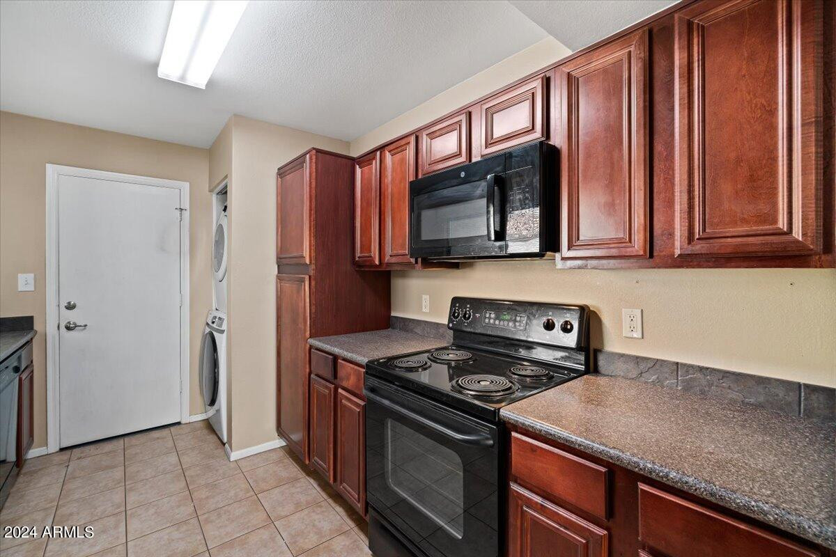 10115 East Mountain View Road, Unit 1102 Scottsdale, AZ 85258 - Photo 14 of 31 a kitchen with stainless steel appliances granite countertop a stove a sink and a microwave