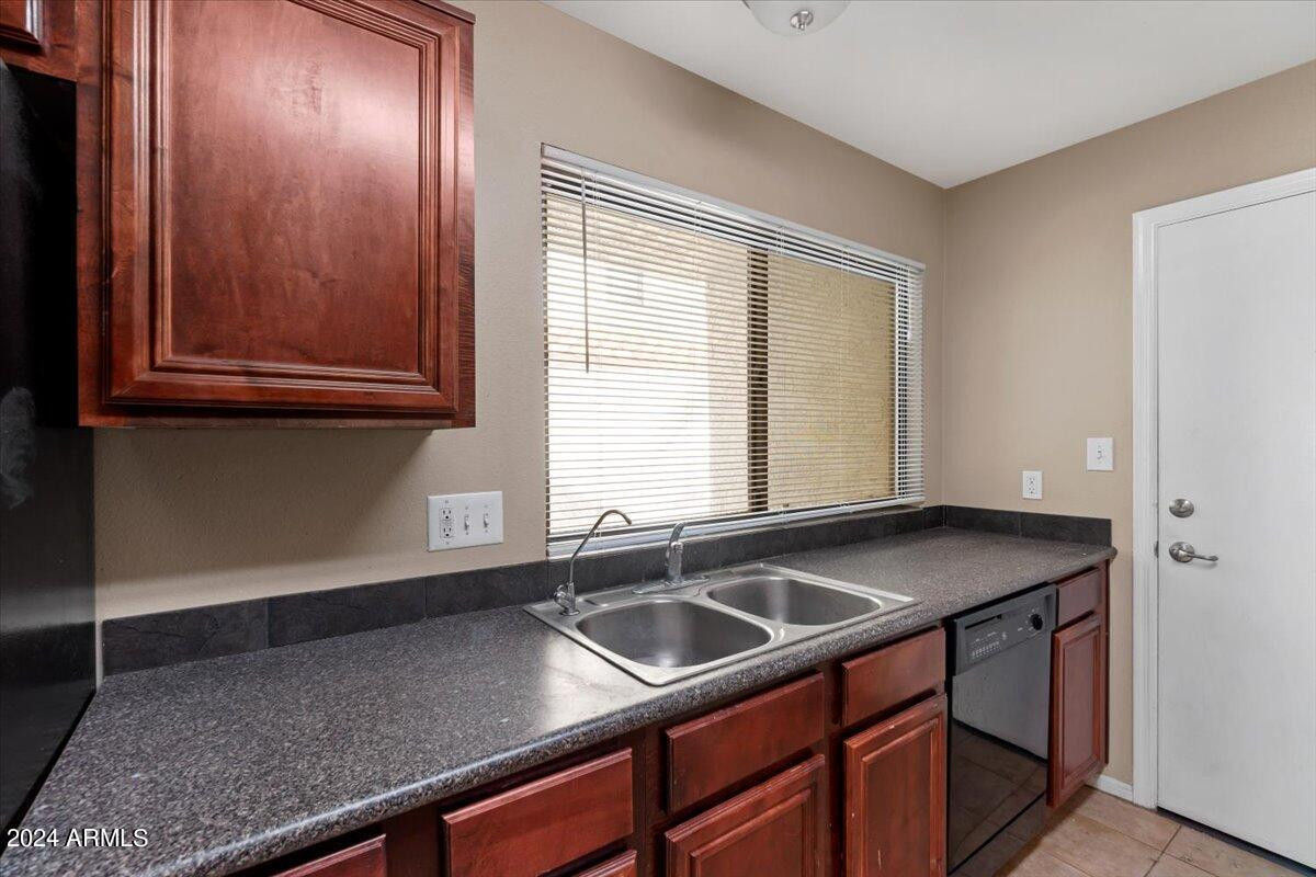 10115 East Mountain View Road, Unit 1102 Scottsdale, AZ 85258 - Photo 15 of 31 a kitchen with stainless steel appliances granite countertop a sink window and cabinets