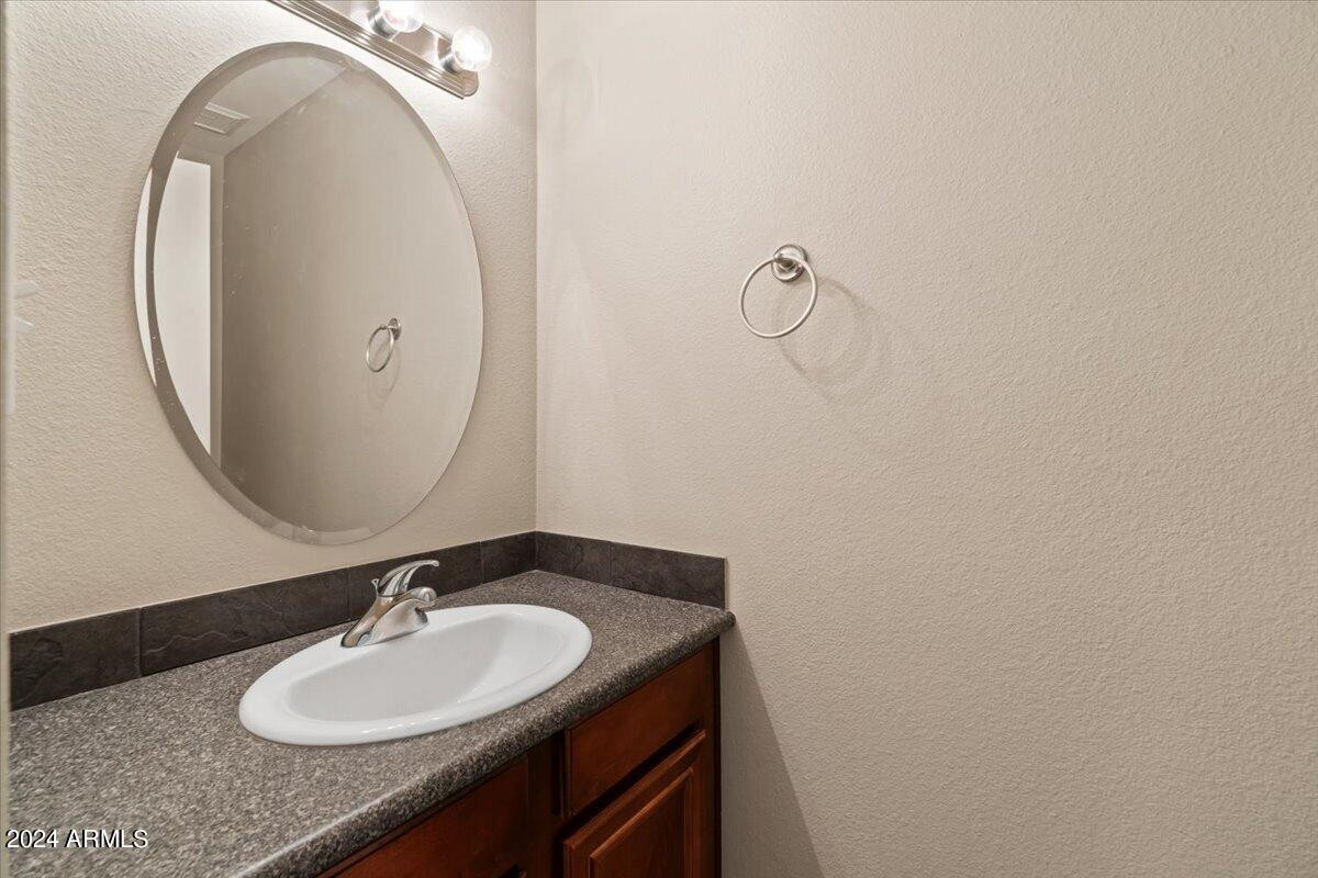 10115 East Mountain View Road, Unit 1102 Scottsdale, AZ 85258 - Photo 17 of 31 a bathroom with a sink and a mirror