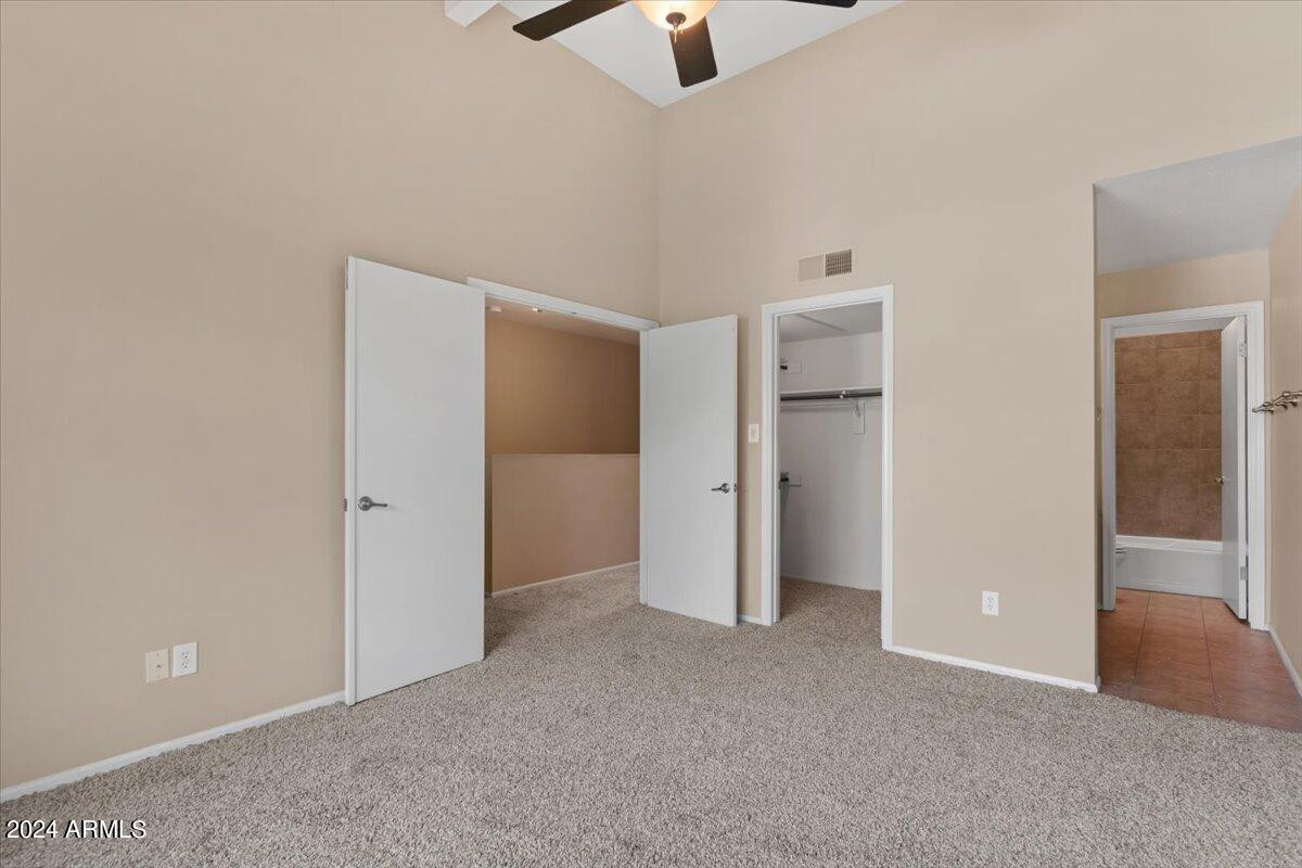 10115 East Mountain View Road, Unit 1102 Scottsdale, AZ 85258 - Photo 20 of 31 an empty room with ceiling fan and window