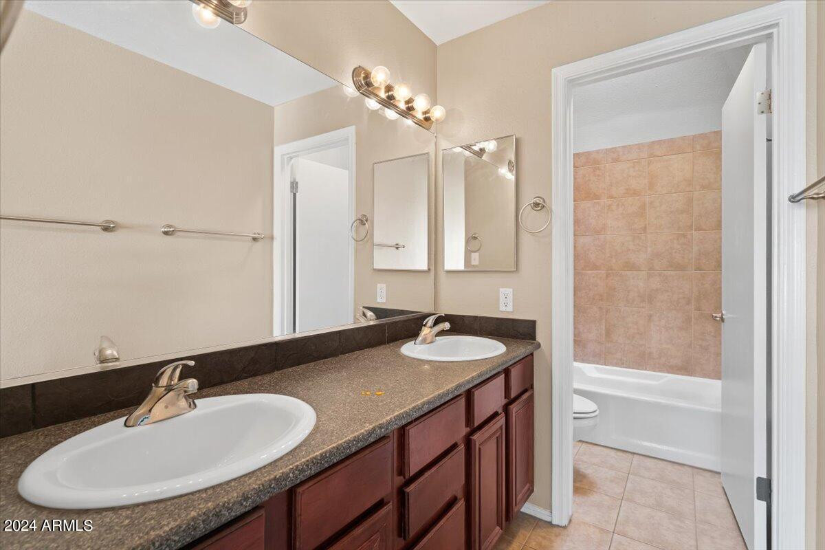 10115 East Mountain View Road, Unit 1102 Scottsdale, AZ 85258 - Photo 21 of 31 a bathroom with a sink and a mirror