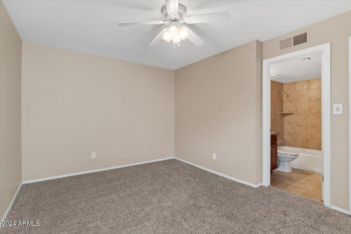 10115 East Mountain View Road, Unit 1102 Scottsdale, AZ 85258 - Photo 23 of 31 an empty room and a bathroom