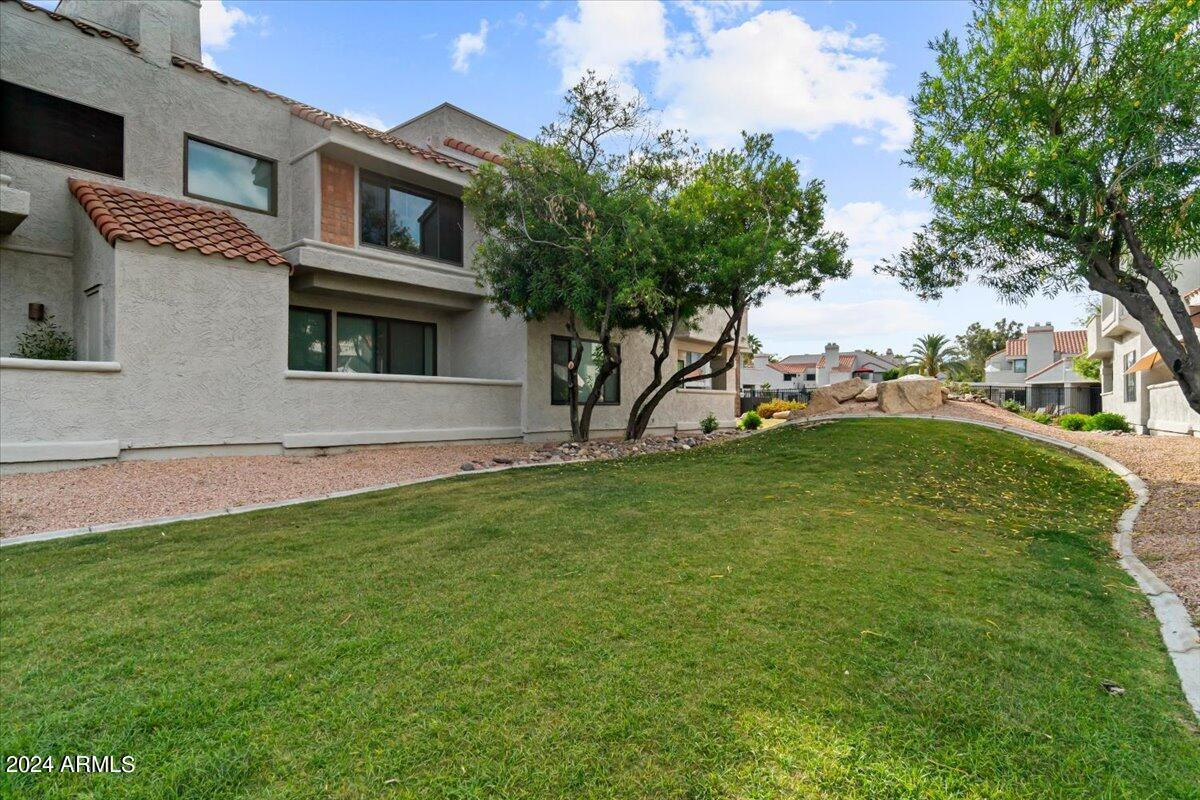 10115 East Mountain View Road, Unit 1102 Scottsdale, AZ 85258 - Photo 28 of 31 a view of a house with a yard