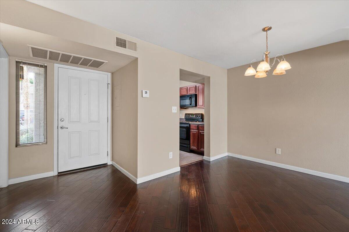 10115 East Mountain View Road, Unit 1102 Scottsdale, AZ 85258 - Photo 6 of 31 an empty room with wooden floor and windows
