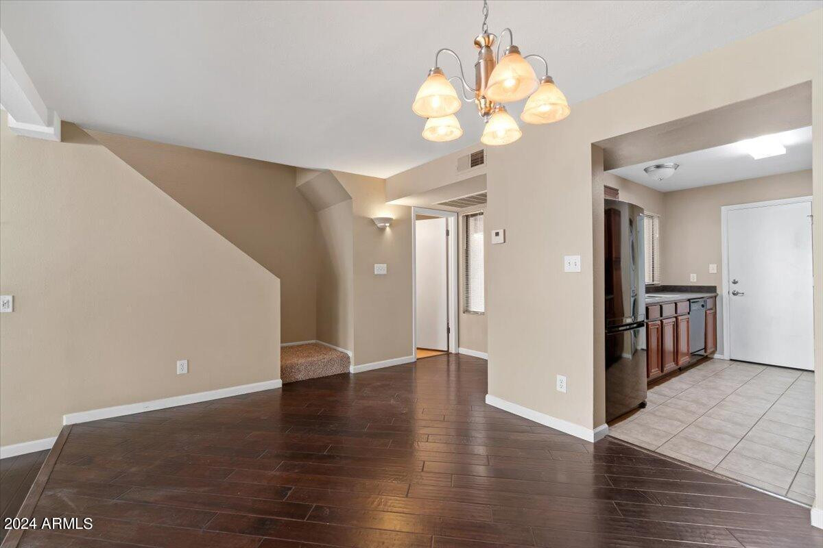 10115 East Mountain View Road, Unit 1102 Scottsdale, AZ 85258 - Photo 7 of 31 a view of an empty room with wooden floor