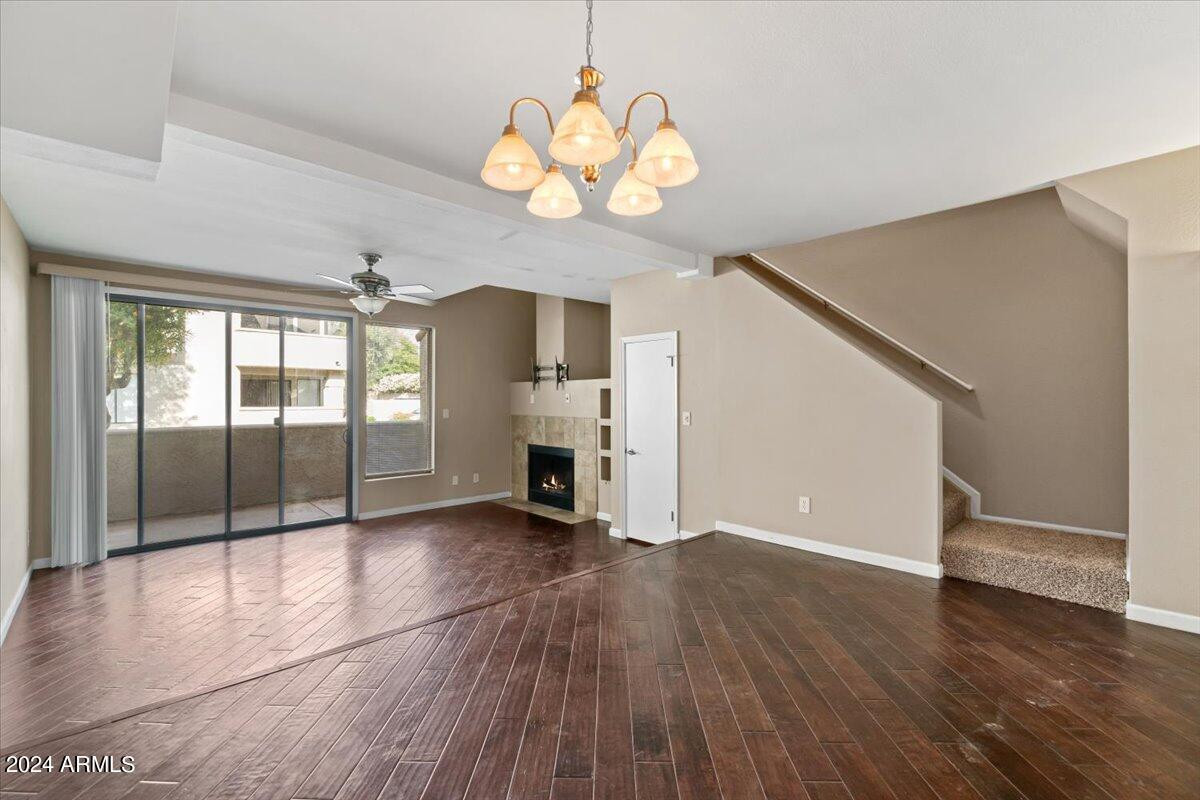 10115 East Mountain View Road, Unit 1102 Scottsdale, AZ 85258 - Photo 8 of 31 a view of an empty room with a window and wooden floor