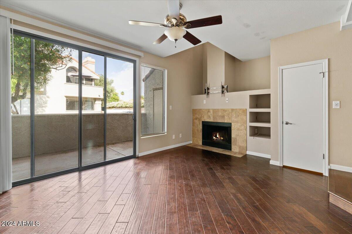 10115 East Mountain View Road, Unit 1102 Scottsdale, AZ 85258 - Photo 10 of 31 a view of an empty room with glass door and wooden floor
