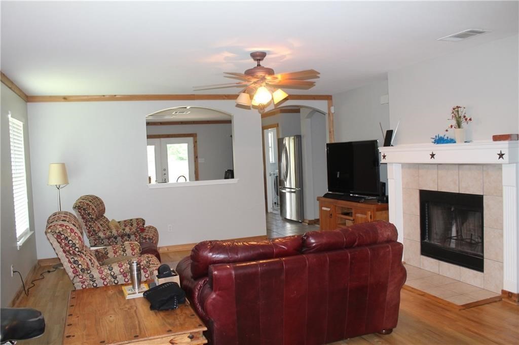 150 Madisons Way Buda, TX 78610 - Photo 2 of 11 a living room with furniture a fireplace and a flat screen tv