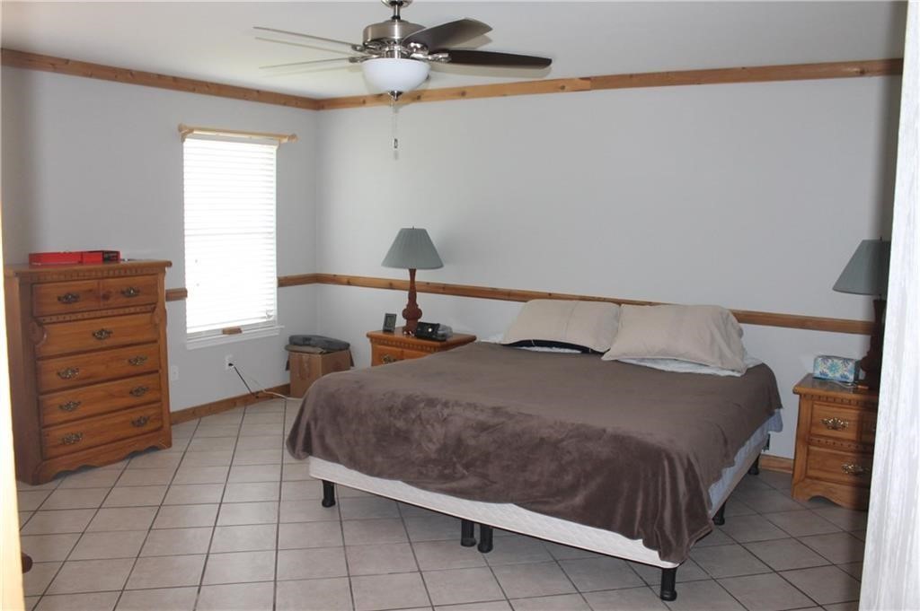 150 Madisons Way Buda, TX 78610 - Photo 4 of 11 a bedroom with a bed and a mirror