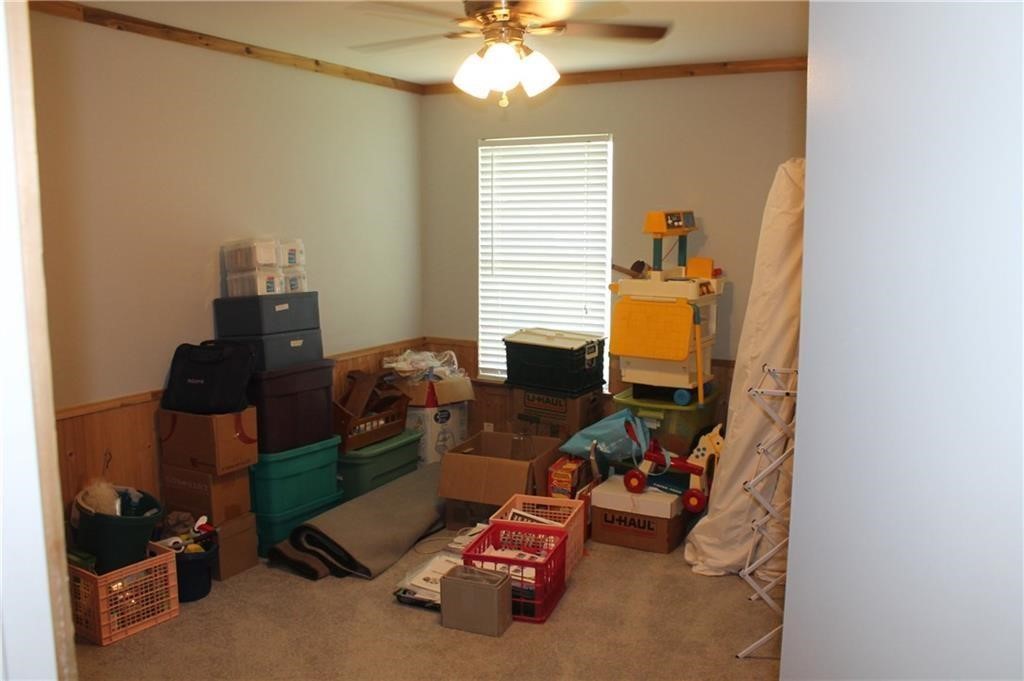 150 Madisons Way Buda, TX 78610 - Photo 7 of 11 a room with furniture and a chandelier fan