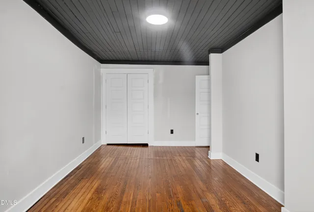 a view of room with wooden floor