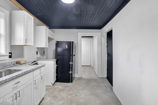 a kitchen with a sink and refrigerator