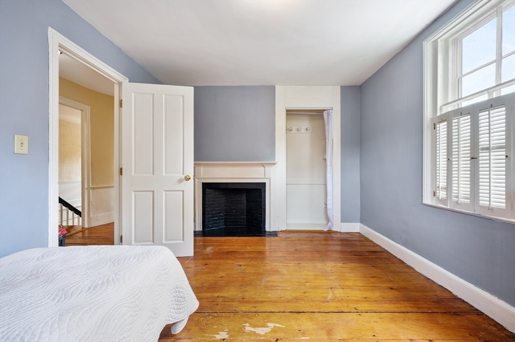 651 Main Street Hingham, MA 02043 - Photo 20 of 42 a spacious bedroom with a bed and a window
