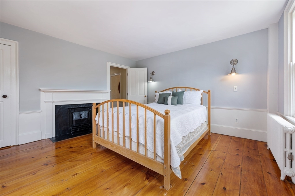 651 Main Street Hingham, MA 02043 - Photo 21 of 42 a bedroom with a bed and a fireplace