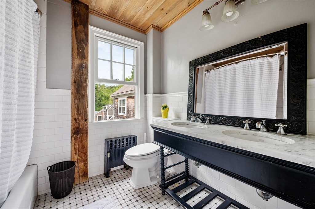 651 Main Street Hingham, MA 02043 - Photo 26 of 42 a bathroom with a sink a toilet and a window