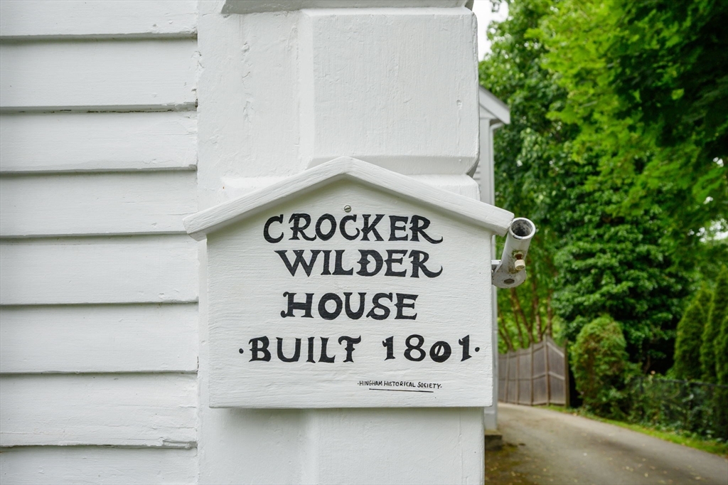 651 Main Street Hingham, MA 02043 - Photo 30 of 42 a white sign that is sitting on a wooden wall