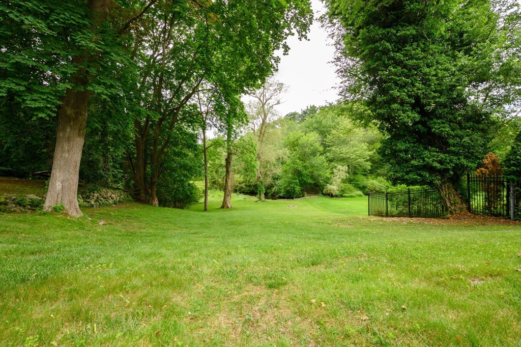 651 Main Street Hingham, MA 02043 - Photo 41 of 42 a view of a grassy field with trees in the background