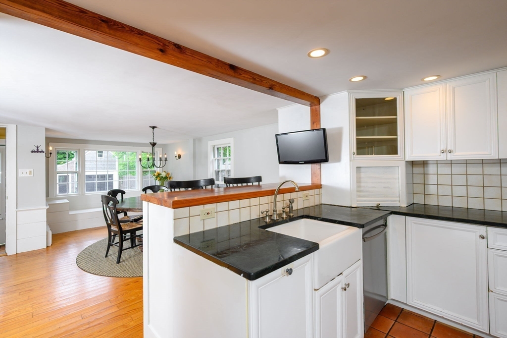 651 Main Street Hingham, MA 02043 - Photo 6 of 42 a kitchen with a sink cabinets and wooden floor