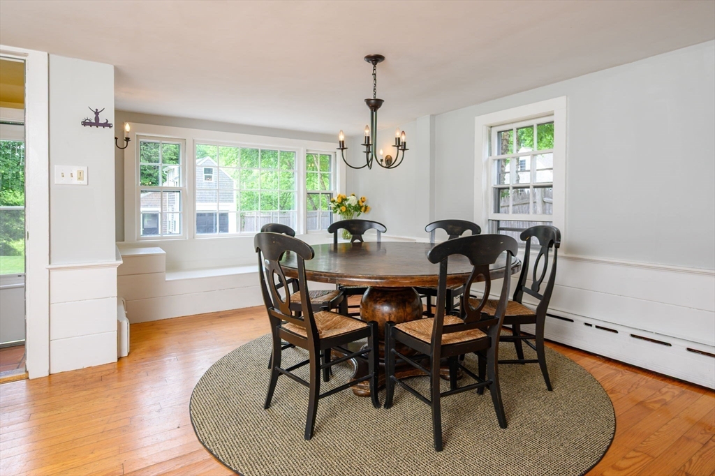 651 Main Street Hingham, MA 02043 - Photo 7 of 42 a dining room with furniture a chandelier and wooden floor