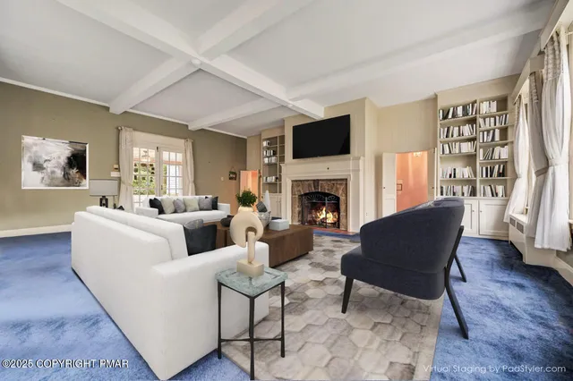 a view of a hallway with wooden floor and furniture