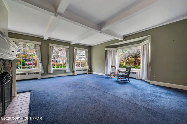 a bedroom with a bed dresser and a window