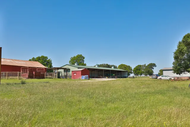 a view of a house with a yard and sitting area
