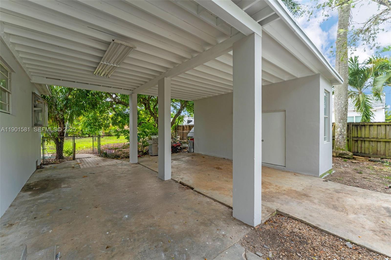 538 Northwest 11th Street Homestead, FL 33030 - Photo 12 of 14 a view of a room with wooden walls and floor to ceiling window