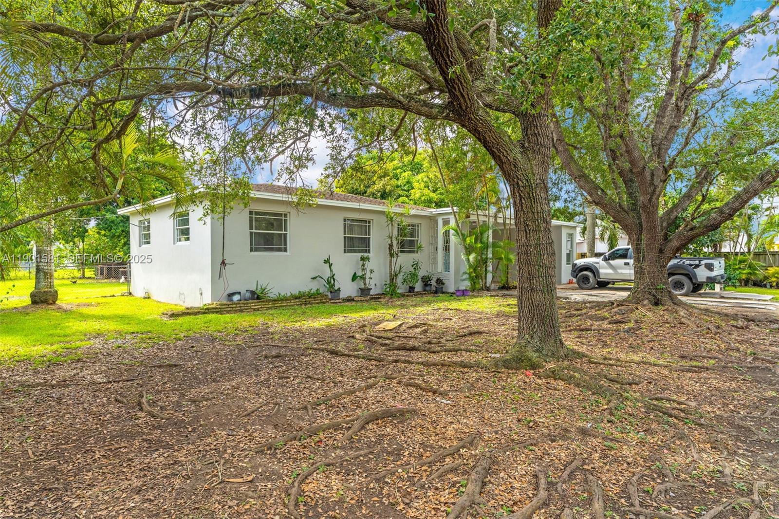 538 Northwest 11th Street Homestead, FL 33030 - Photo 2 of 14 a house that has a tree in front of it