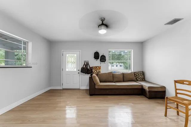 a living room with furniture and a large window