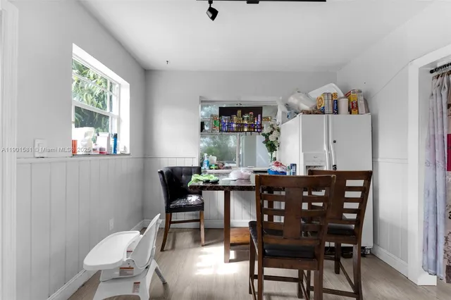 a view of a dining room with furniture and window